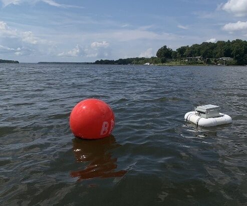 Image of student made buoy floating in water collecting data