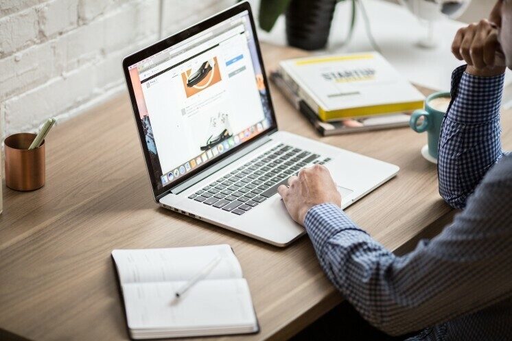 Man sitting in front of a laptop