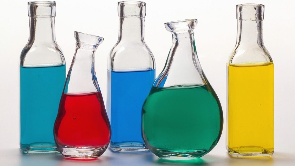 Colorful liquids in bottles representing chemicals