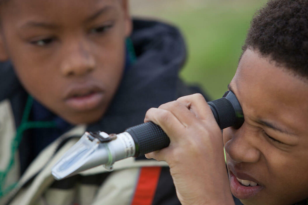 Student looks through a salinity refractometer