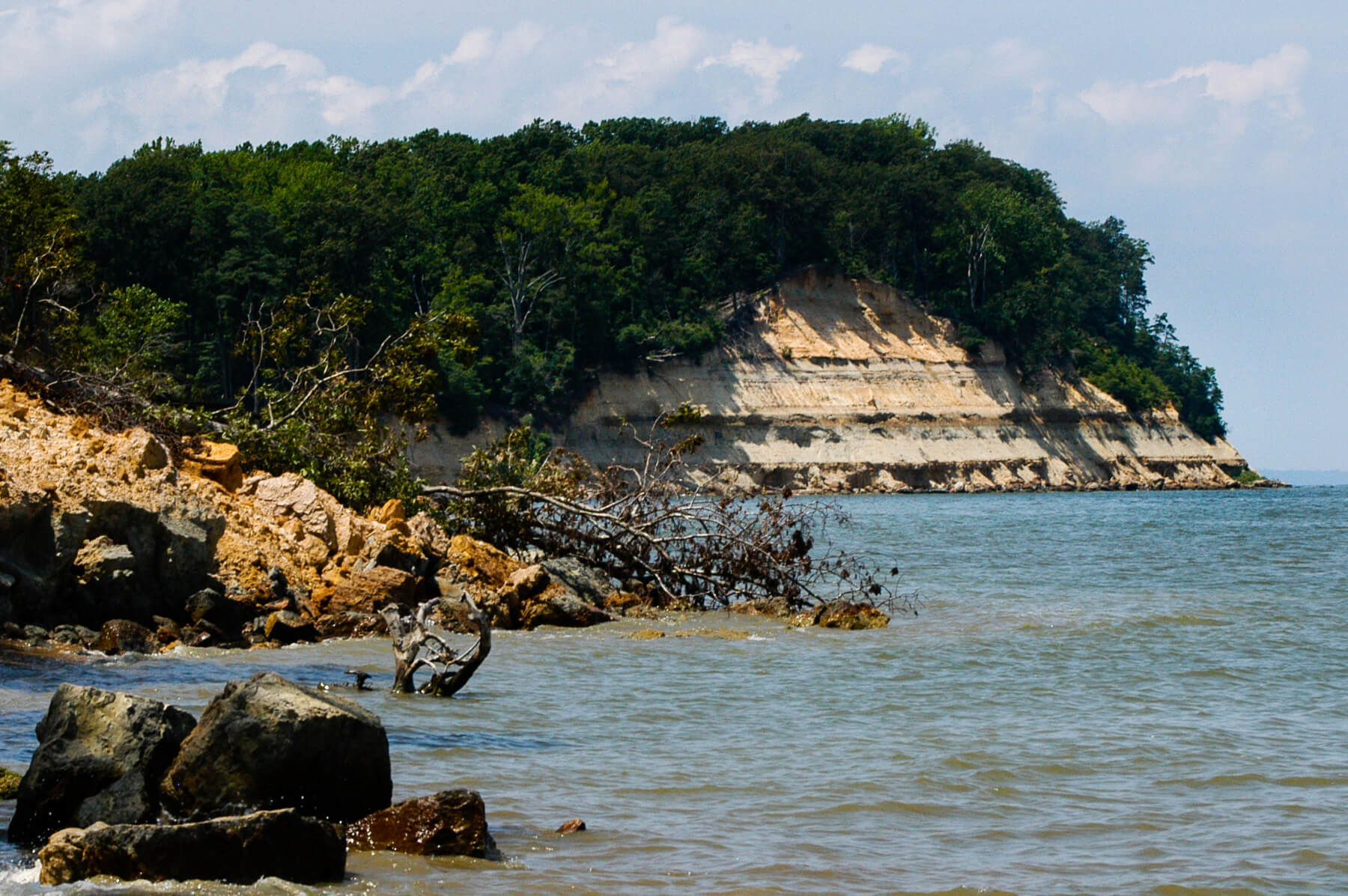 An image of a cliffside showing the layers of built up sediment over time