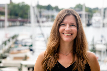 Lucinda with a busy harbor in the background.